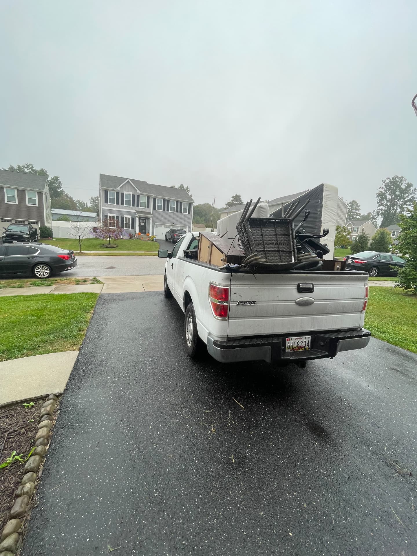 White pickup truck loaded with hauled furniture and junk from a Parkville junk removal job
